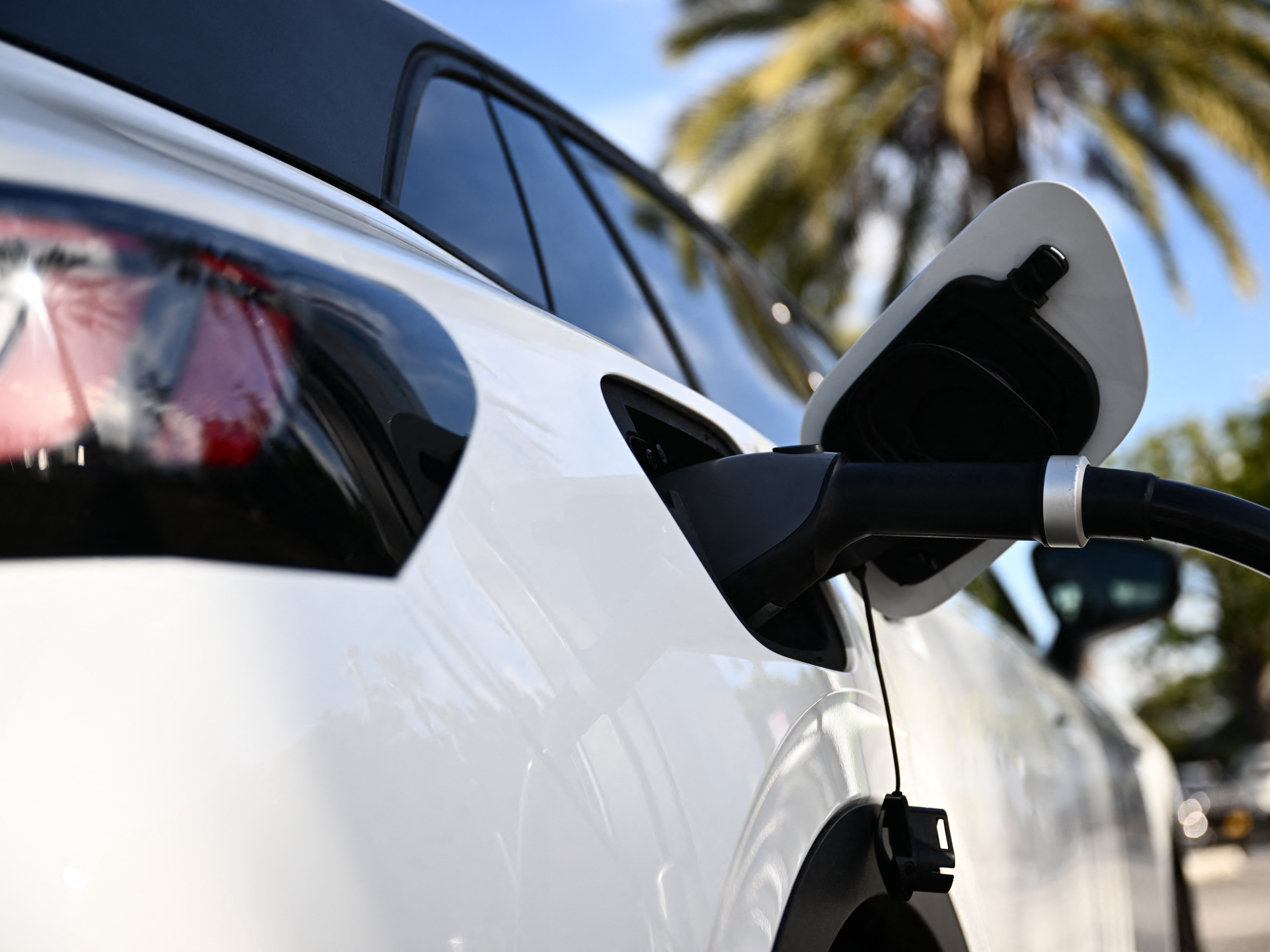 caption: A Volkswagen ID.4 electric vehicle charges via a fast charger in Torrance, Calif., on February 23, 2024. A federal program to fund fast chargers across the U.S. has been on pause for six months, but the Trump administration is now restarting it.