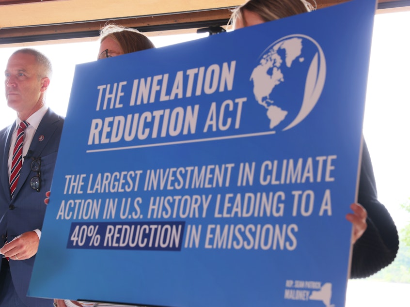 caption: A sign touting the Inflation Reduction Act is seen at Glynwood Boat House in Cold Spring, N.Y., on Aug. 17, 2022.