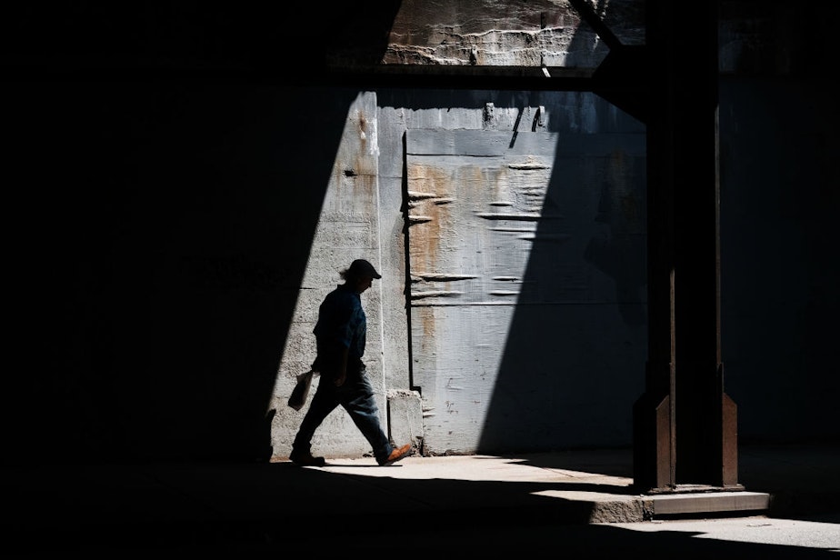 caption: A man walks along a street in Lawrence on August 16, 2019. (Spencer Platt/Getty Images)