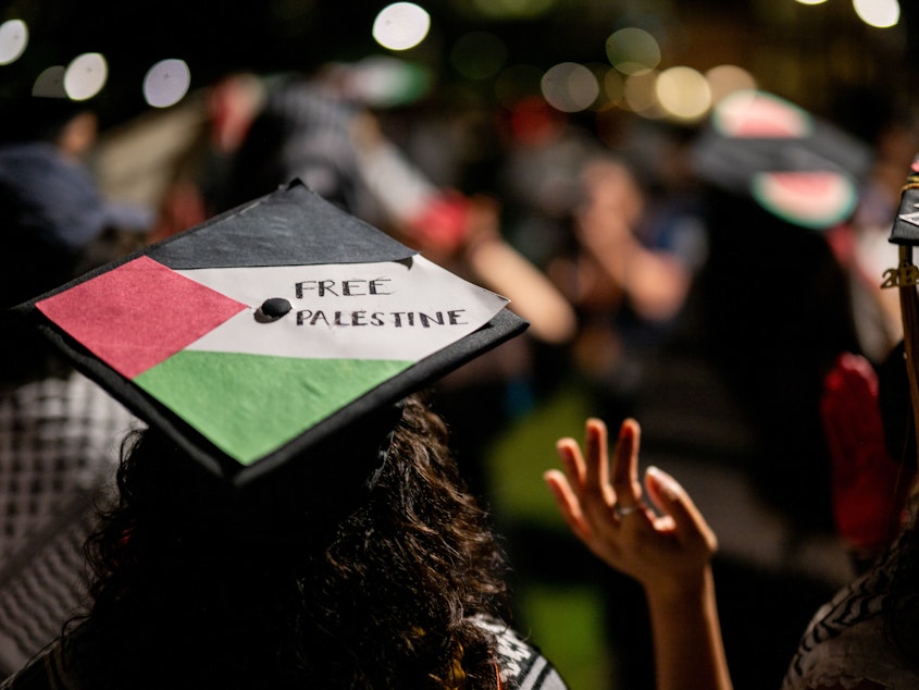 caption: Graduate students and demonstrators at the University of Texas at Austin protest the war in Gaza after walking out of commencement at the DKR-Texas Memorial Stadium on May 11, 2024 in Austin.