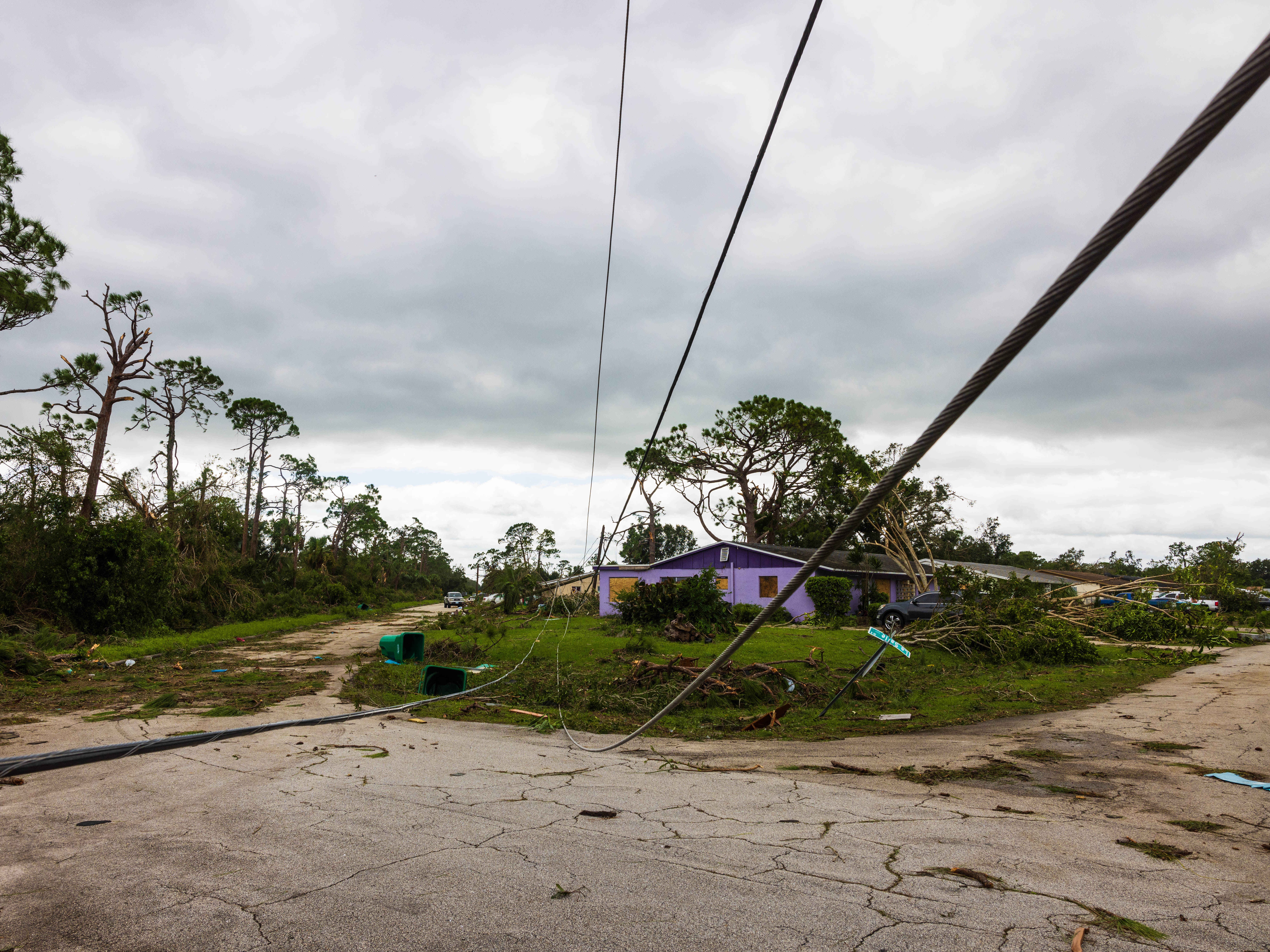 caption: A downed power line and other damage from a tornado caused by Hurricane Milton is seen in Port St Lucie, Fla., on Thursday. The storm triggered some 126 tornado warnings in a short period of time, raising alarms about the impending large hurricane.