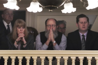 caption: Rob Spencer, center, prays as New Hampshire lawmakers debate prior to a death penalty vote at the State House in Concord, N.H., Thursday. The legislature abolished capital punishment by overriding a veto by Gov. Chris Sununu.