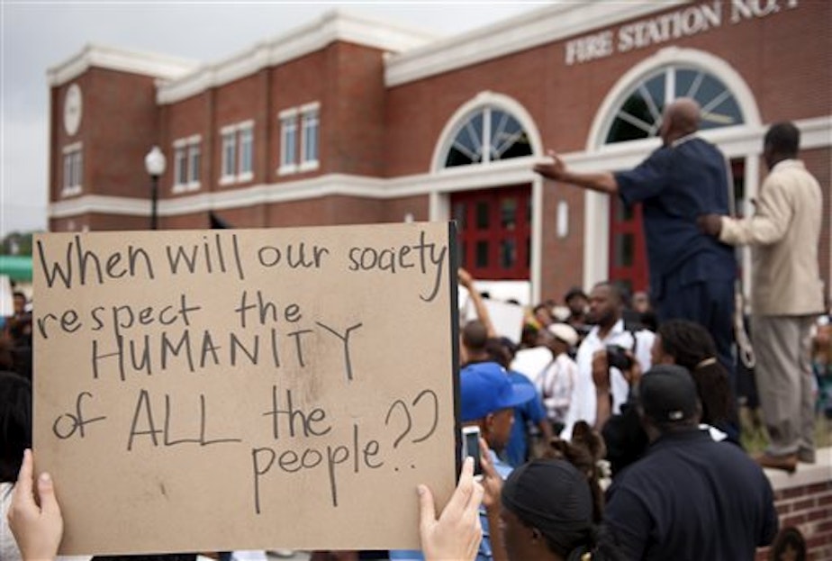 caption: Protestors rally Sunday, Aug. 10, 2014 to protest the shooting of Michael Brown, 18, by police in Ferguson, Mo.