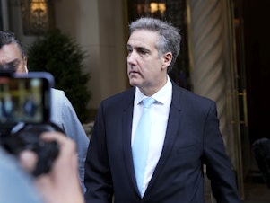 caption: Michael Cohen, former President Donald Trump's fixer, leaves his apartment building in New York this morning.