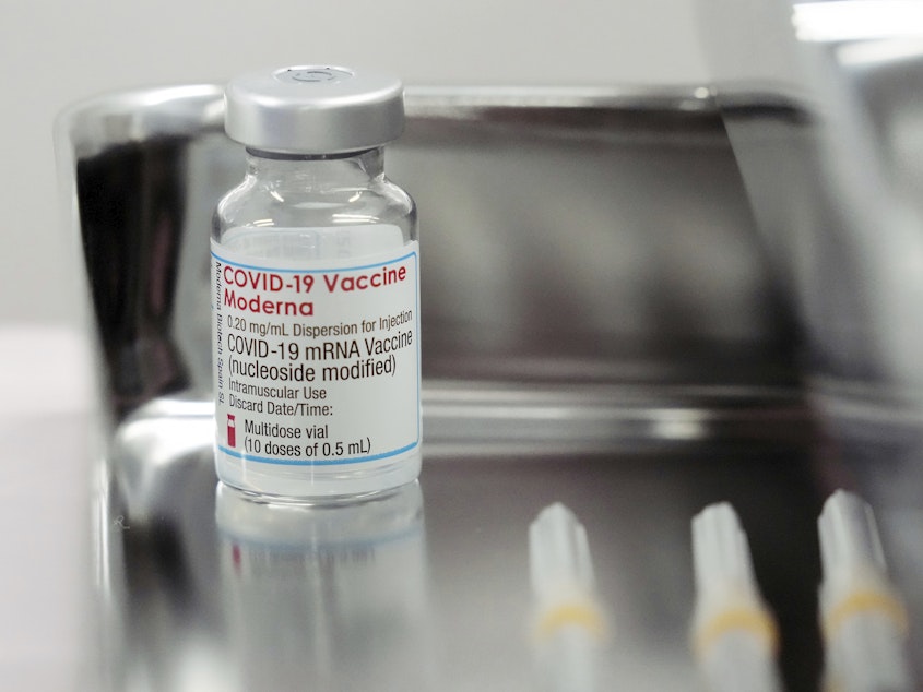 caption: This June 14, 2021, file photo shows a Moderna COVID-19 vaccine vial that is being administered for flight attendants of Japan Airlines at Haneda Airport in Tokyo.