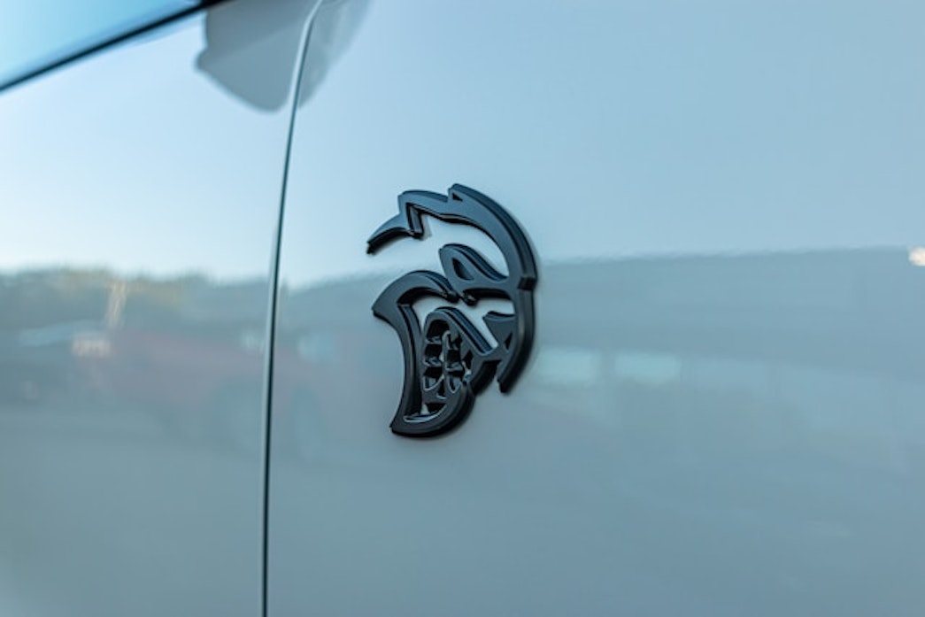 caption: The emblem of a Dodge Charger Hellcat. In March 2024, a 20-year-old man was charged with reckless driving in Seattle after months of allegedly driving his Hellcat through Belltown and downtown streets, loudly revving his engine and street racing. He allegedly reached more than 100 mph on downtown streets with 25 mph speed limits. 