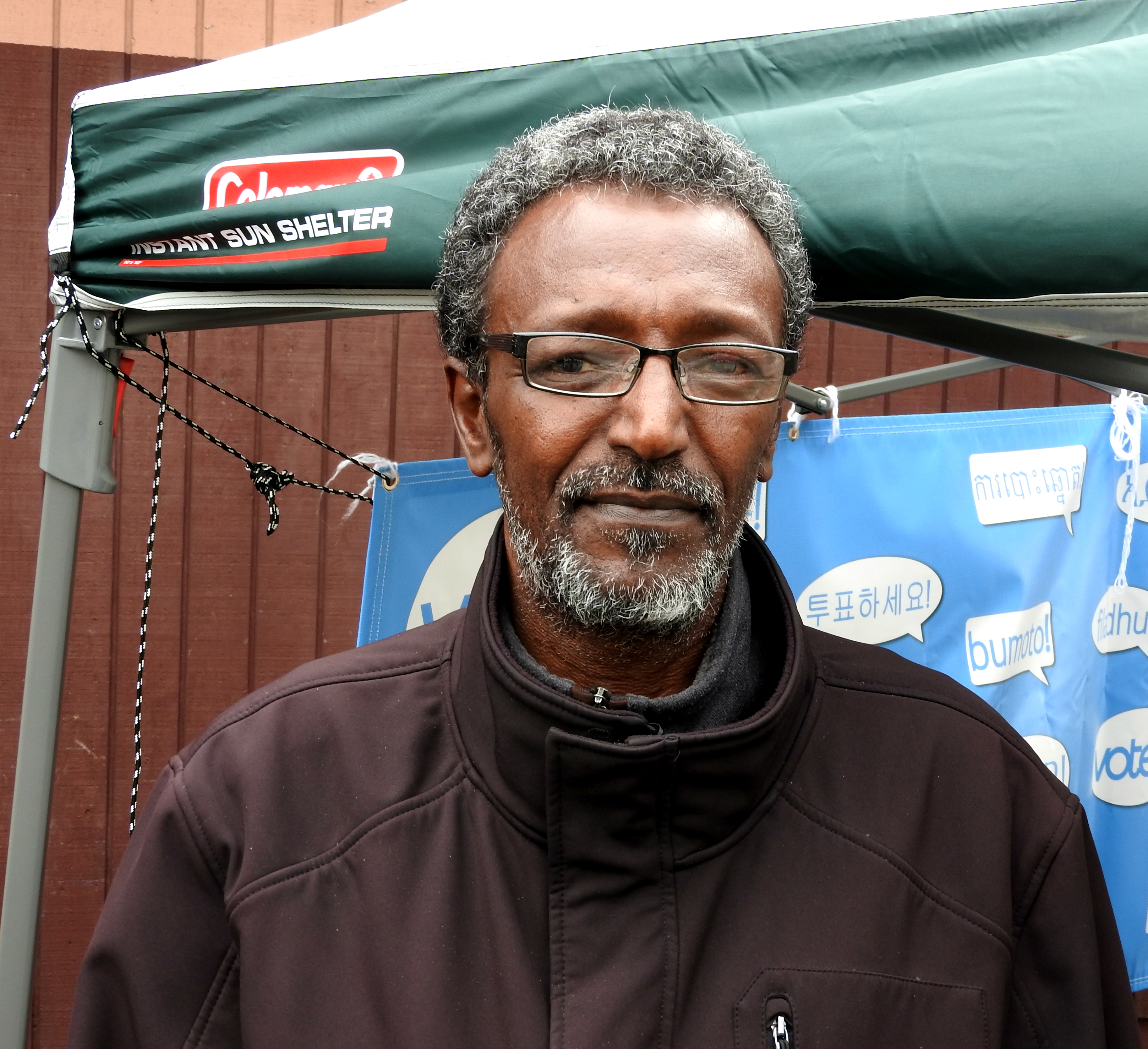 caption: Rashid Abdi registers to vote for the first time