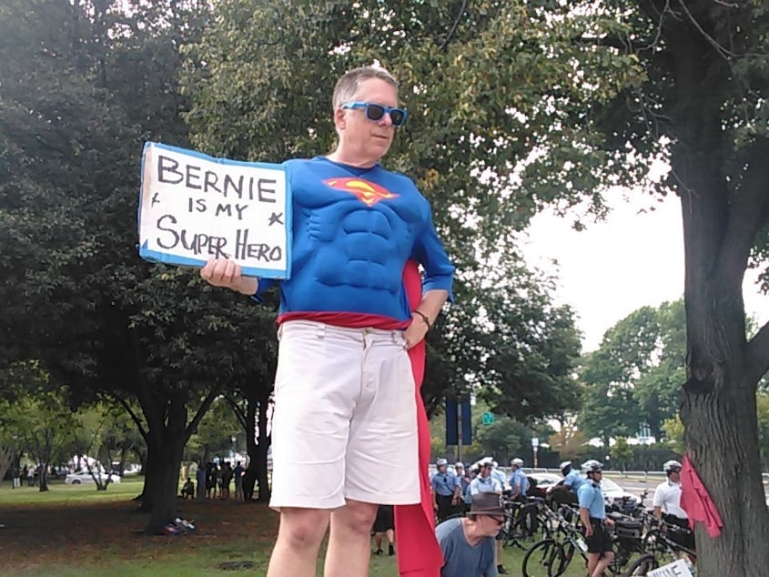caption: A Bernie Sanders supporter demonstrates outside the Democratic National Convention in Philadelphia on Monday, July 25.