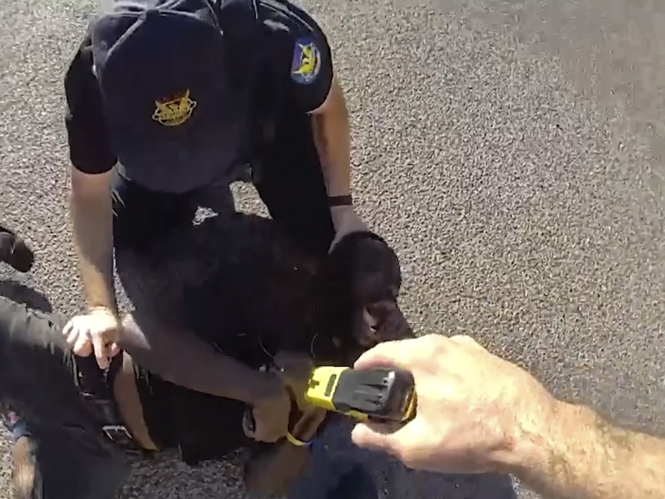 caption: This image from Phoenix Police Department body camera footage from Aug. 19 shows Tyron McAlpin, a Black man who is deaf, being punched and shocked with a Taser by Phoenix police officers when they responded to a call that he had committed an assault at a convenience store, according to police.