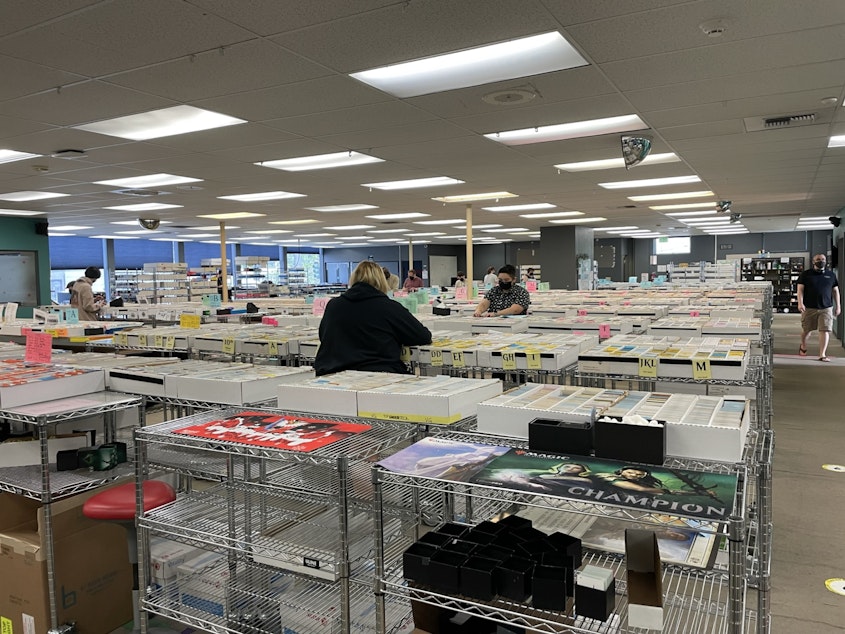 caption: Since Covid, Card Kingdom's workers are spread out more while they work. The company employs 180 workers, spread out over three shifts, including an overnight shift.