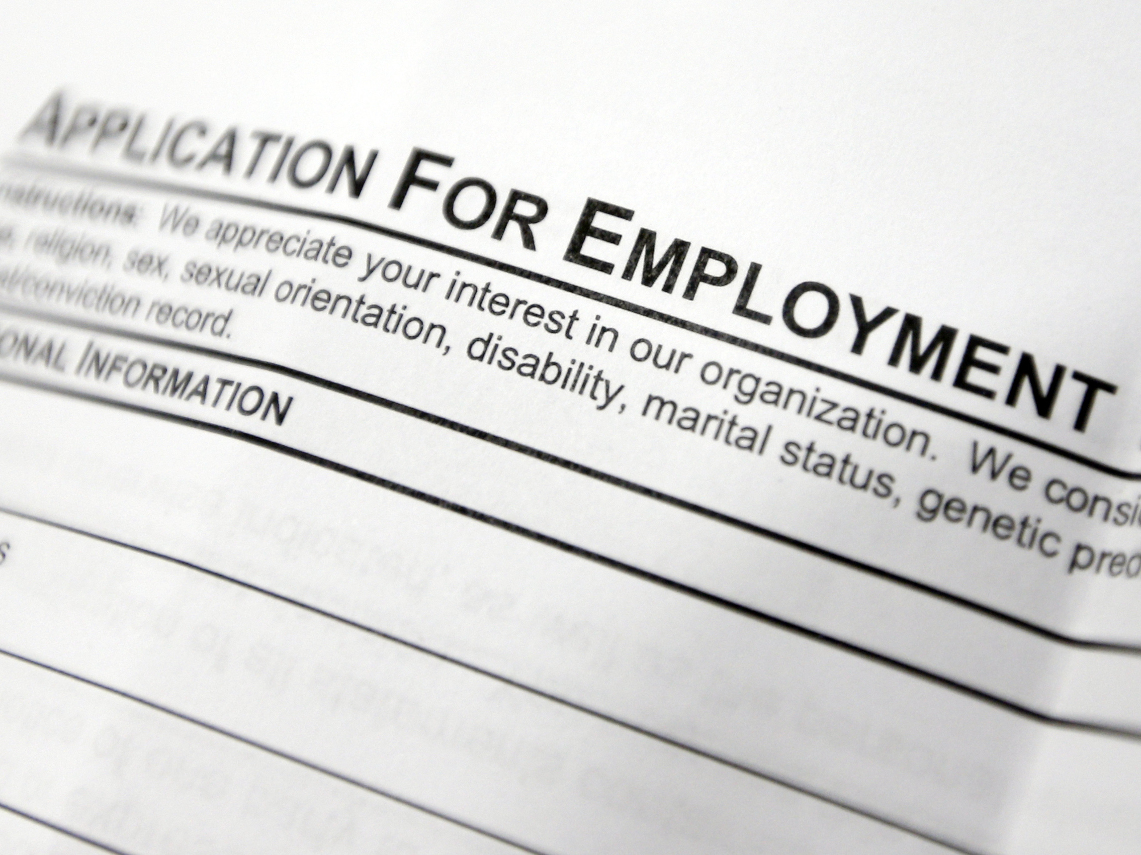 caption: This April 22, 2014, file photo shows an employment application form on a table during a job fair at Columbia-Greene Community College in Hudson, N.Y.