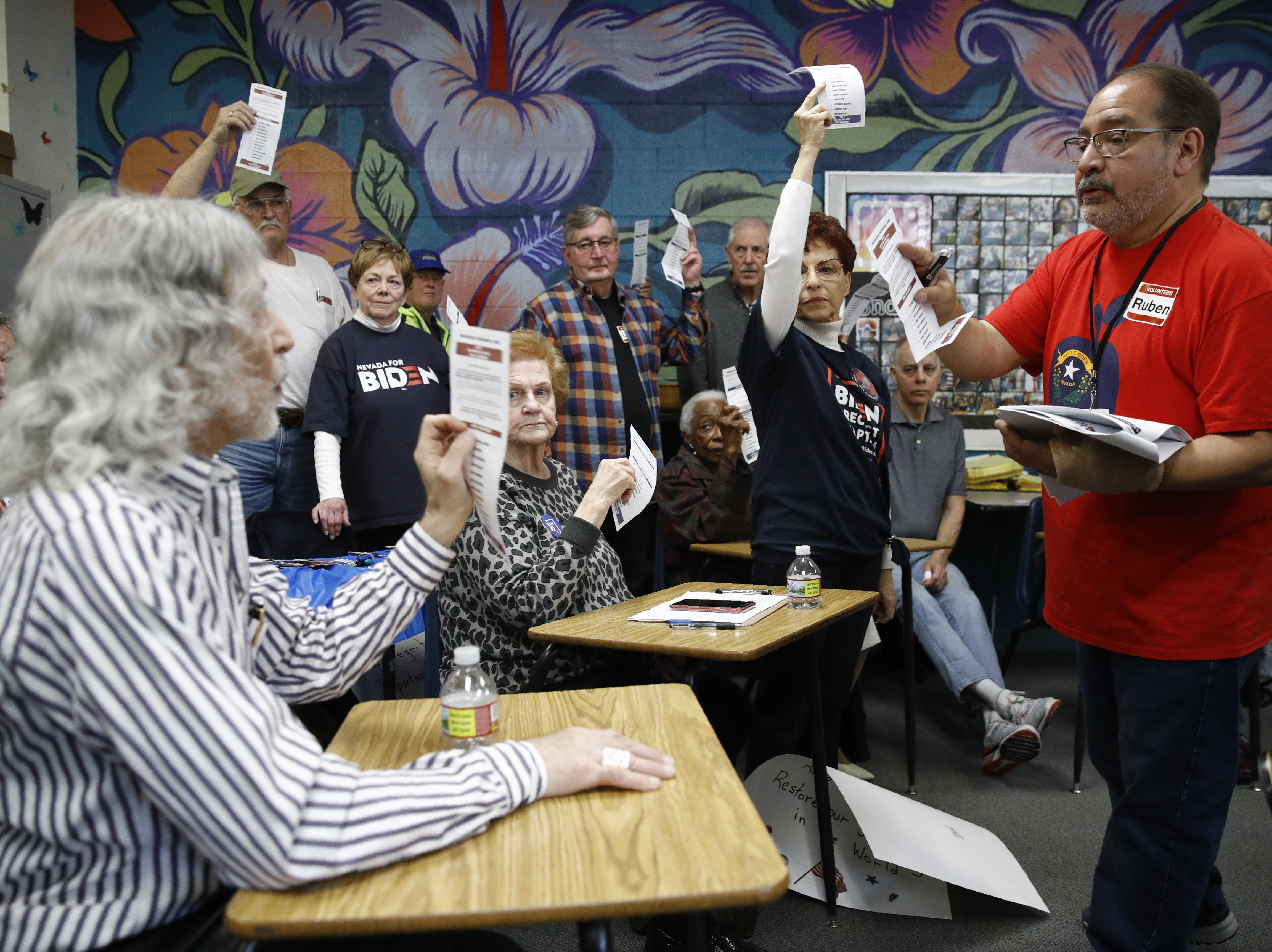 caption: A precinct leader, right, counts votes at a caucus location at Coronado High School in Henderson, Nev., on Saturday.