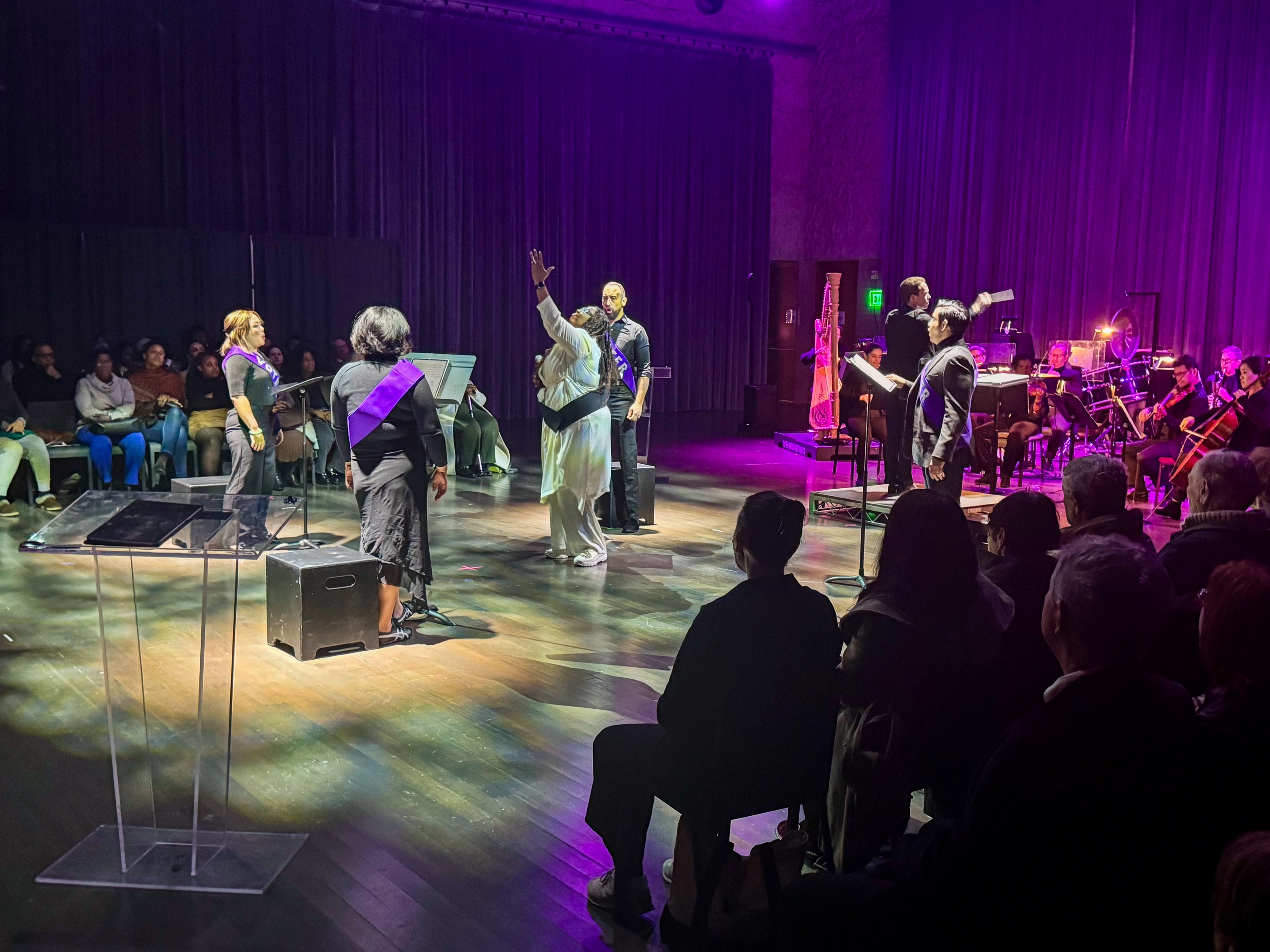 caption: Librettist Deborah D.E.E.P. Mouton (center) narrates <em>Future of Dreams</em>, an opera composed by Jaylin Vinson about two Black women running for mayor of Houston in 2064.