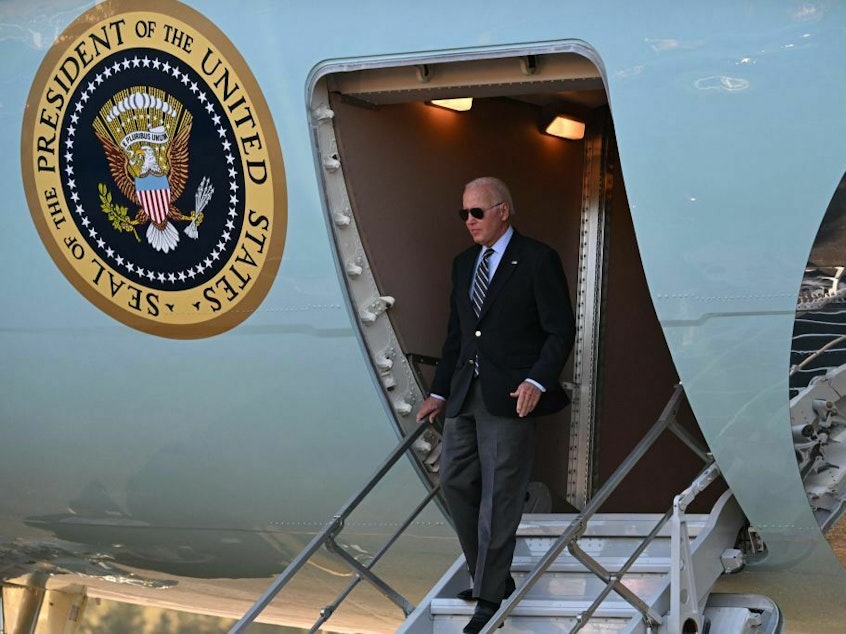 caption: President Biden disembarks Air Force One at Grand Canyon National Park Airport in Grand Canyon Village, Ariz., on Monday.
