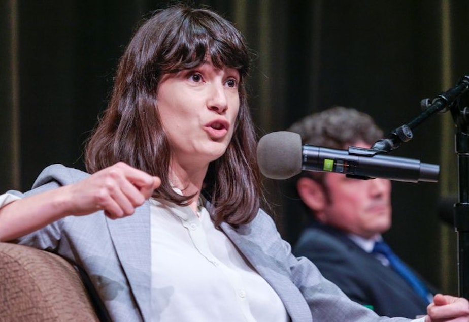 caption: Marie Gluesenkamp Perez, the Democratic candidate in Washington state's 3rd Congressional District race, speaks at a debate moderated by "Think Out Loud" host Dave Miller. The debate between her and her Republican challenger, Joe Kent, was held at the Wollenberg Auditorium on the campus of Lower Columbia College in Longview, Washington on October 27, 2022.