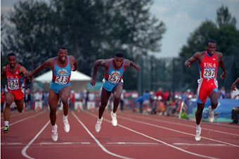 caption: Leroy Burrell, left, lunges across the finish line to beat Carl Lewis in the Goodwill Games 100-meter race in Seattle Monday night July 23, 1990. 