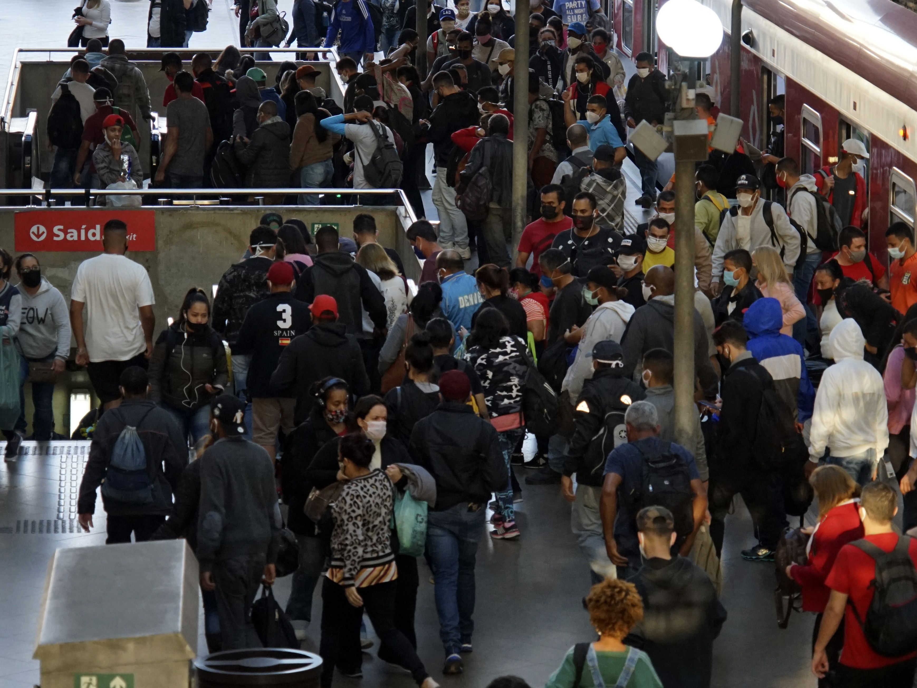 caption: Commuters at the Luz station in São Paulo. Brazil has the world's second-highest number of COVID-19 cases after the U.S.