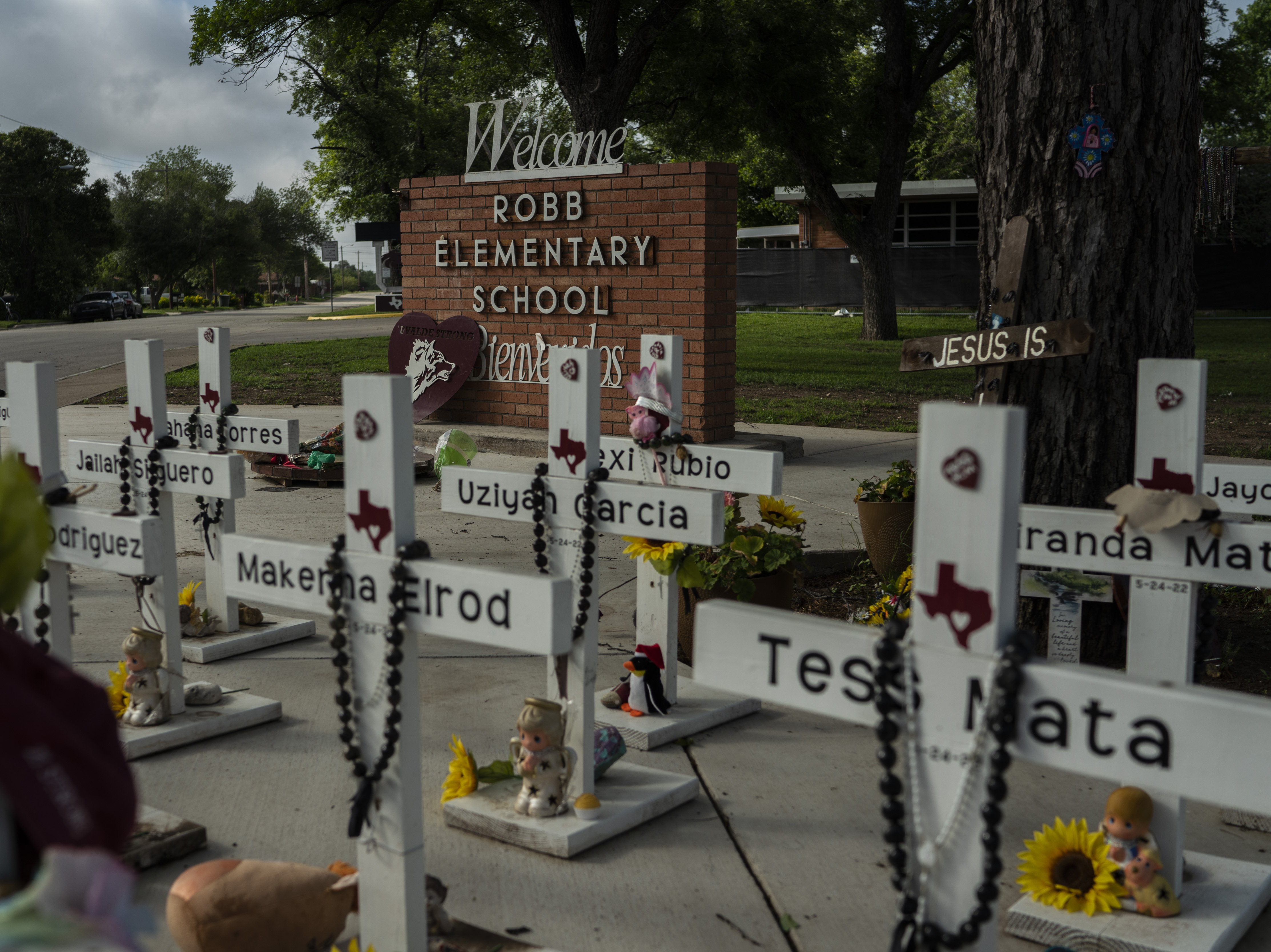caption: The memorial at Robb Elementary School in Uvalde, Texas. A mass shooting there on May 24, 2022, killed 19 children and two teachers. For surviving families, the year since has been an agonizing fight for answers and accountability.