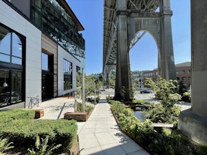 caption: "Watershed" is the name of the building Weber Thompson designed and now occupies in Fremont. In this photo, it's visible on the left, under the Aurora Bridge.