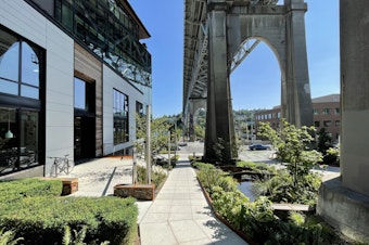 caption: "Watershed" is the name of the building Weber Thompson designed and now occupies in Fremont. In this photo, it's visible on the left, under the Aurora Bridge.