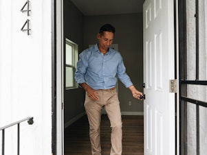 caption: Dan Valdez, housing acquisitions manager for the nonprofit Brilliant Corners, checks out a recently leased property near downtown Los Angeles.