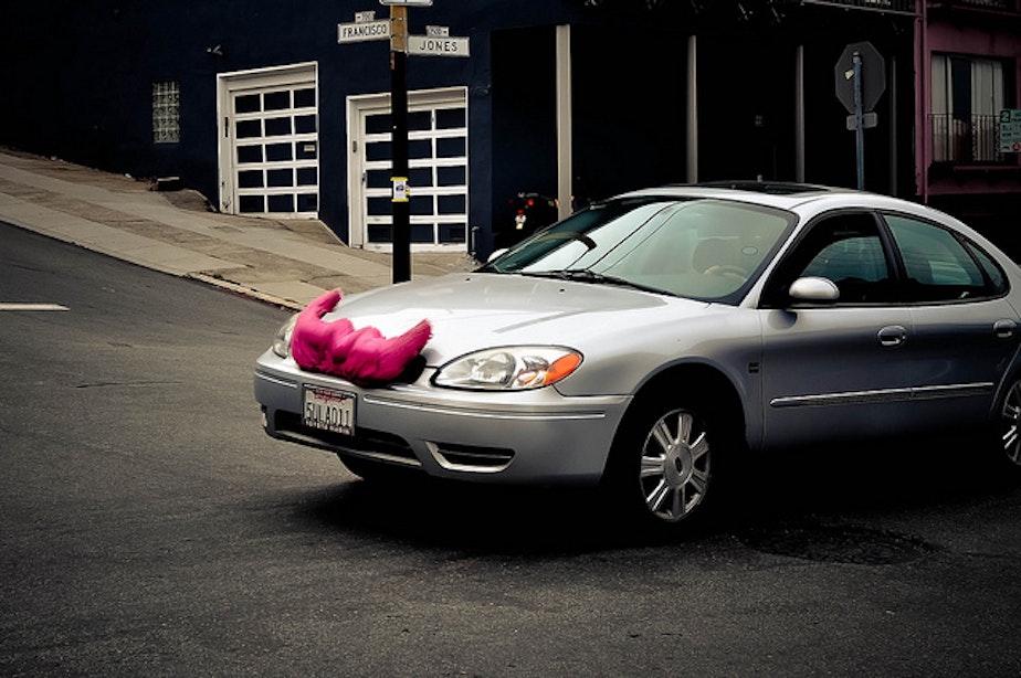 caption: Ride-sharing company Lyft distinguishes itself with a fuzzy pink mustache on participants' cars.