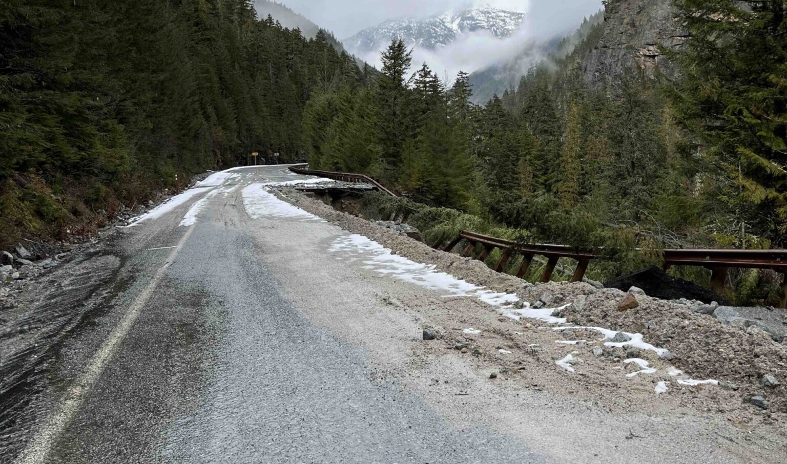 caption:  Damage on State Route 20 through the North Cascades following the winter of 2025-26. State transportation officials didn’t have a timeline for getting the road reopened as of May 1. 
