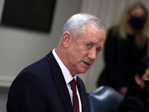 caption: Benny Gantz speaks at the Pentagon in December 2021 in Arlington, Va. Gantz, a former army chief and current minister in Israel's three-member war cabinet, said he would quit the government in three weeks if Prime Minister Benjamin Netanyahu does not advance a plan to replace Hamas in Gaza.