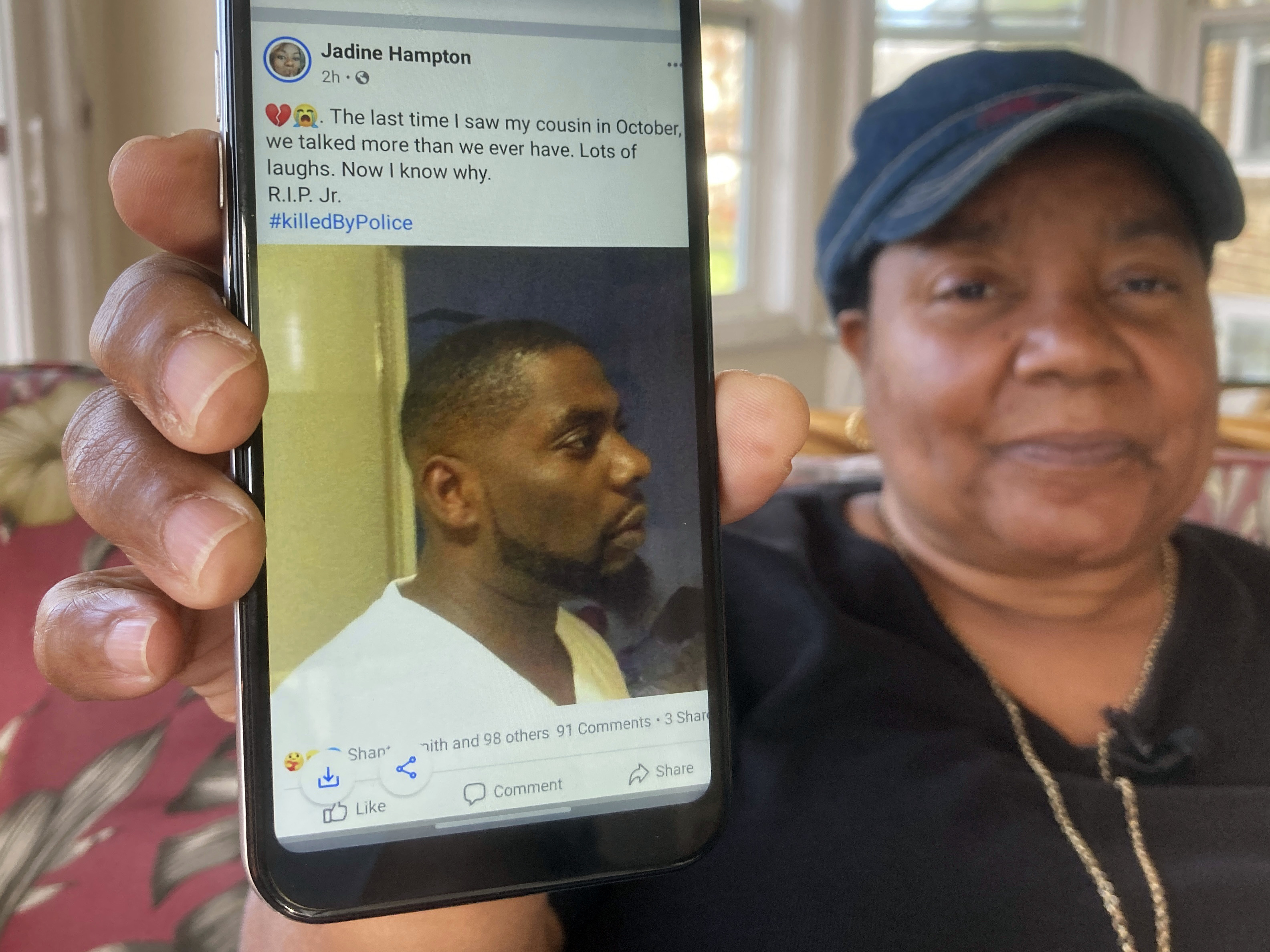 caption: Andrew Brown Jr. was shot in the back of his head, his family's attorneys said on Tuesday, citing an independent autopsy. Here, Glenda Brown Thomas displays a photo of Brown, her nephew, on her cell phone at her home in Elizabeth City, N.C.