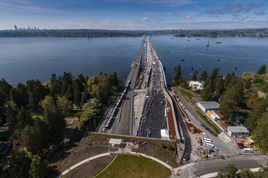 caption: People cover the westbound lanes (right) of state Route 520 during festivities on April 2.