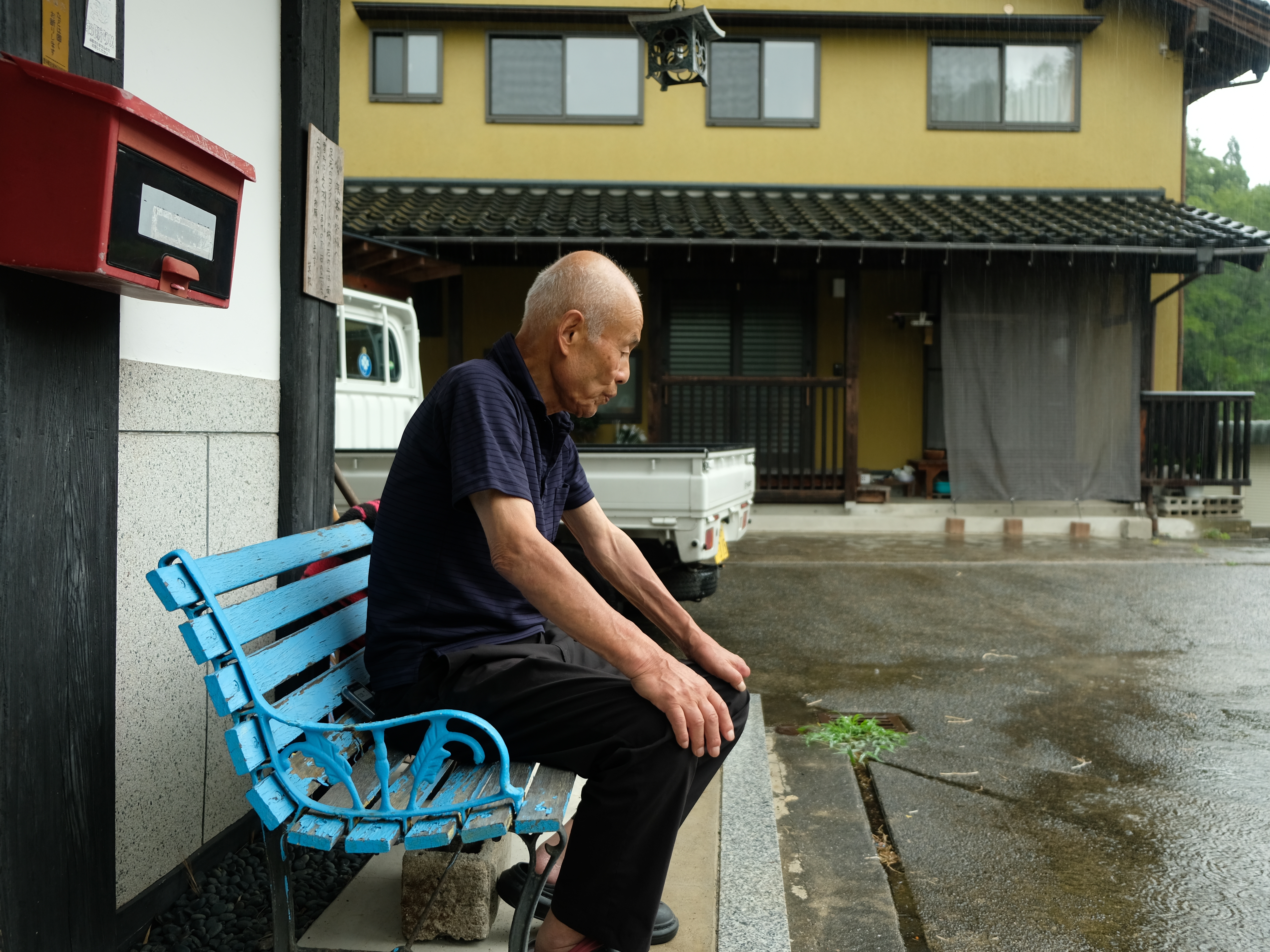 caption: Toshiyuki Mimaki, 83, co-chair of Nihon Hidankyo, a Nobel Peace Prize-winning group of a-bomb survivors in Japan, sits outside his farmhouse, about 10 miles outside the city of Hiroshima.