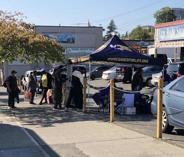 caption: Renegades for Life Youth Outreach, a nonprofit organization, hosts weekly street outreach pop-ups at 12th and Jackson in Seattle's Chinatown-International District on Friday, September 30, 2022.