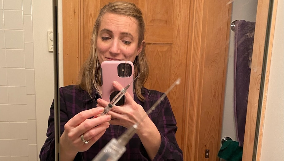 caption: Anna Scott with a "shockingly long" needle for invitro fertilization treatments.