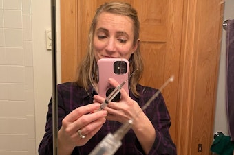 caption: Anna Scott with a "shockingly long" needle for invitro fertilization treatments.