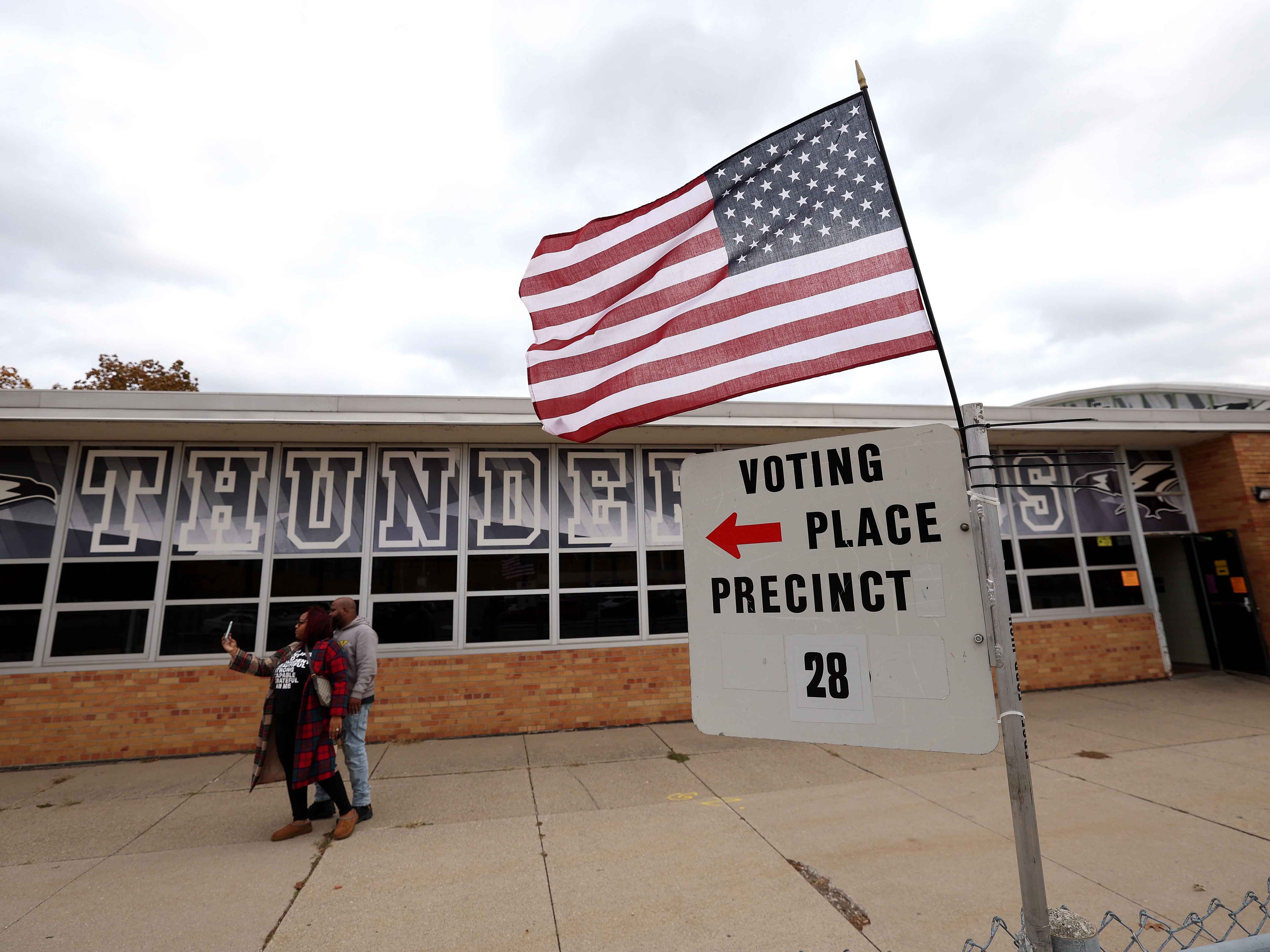caption: Voters take a selfie after casting ballots at Edsel Ford High School on Nov. 5 in Dearborn, Mich.