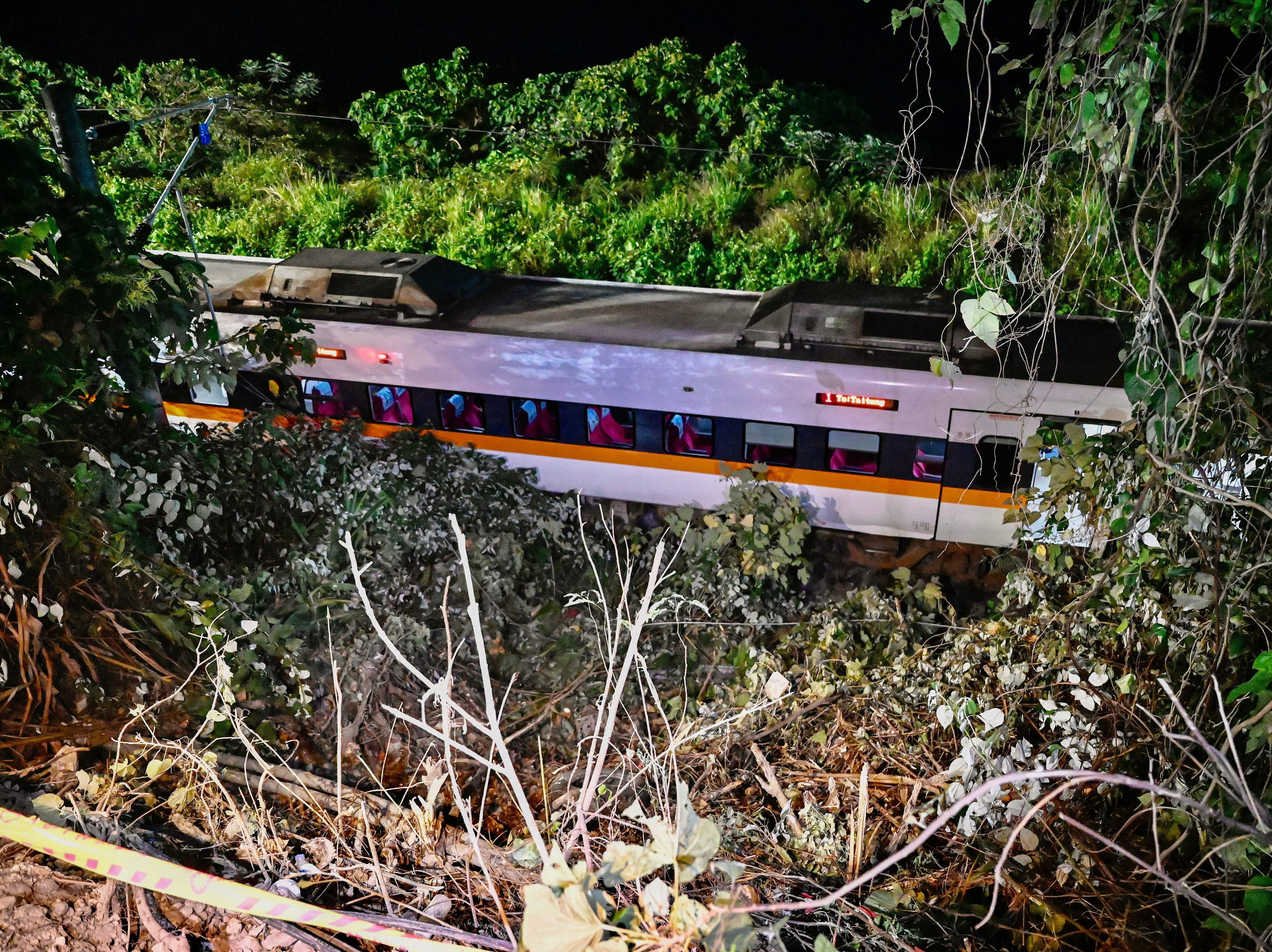 caption: A section of a train that derailed inside a tunnel in the mountains of Hualien in eastern Taiwan on Friday.