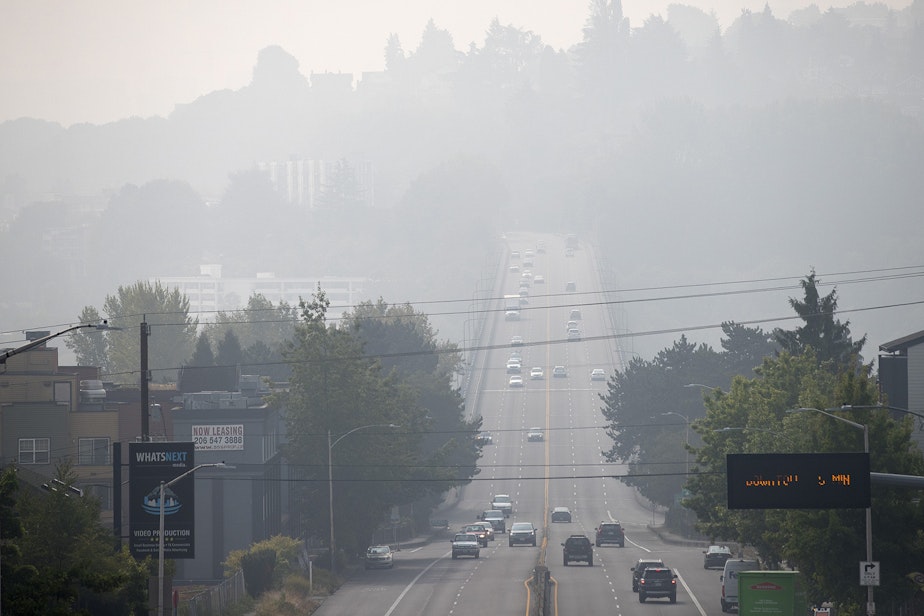 caption: Vehicles travel across the Aurora Bridge as a massive plume of smoke from wildfires burning in California and Oregon makes it's way into the area, on Friday, September 11, 2020, in Seattle.