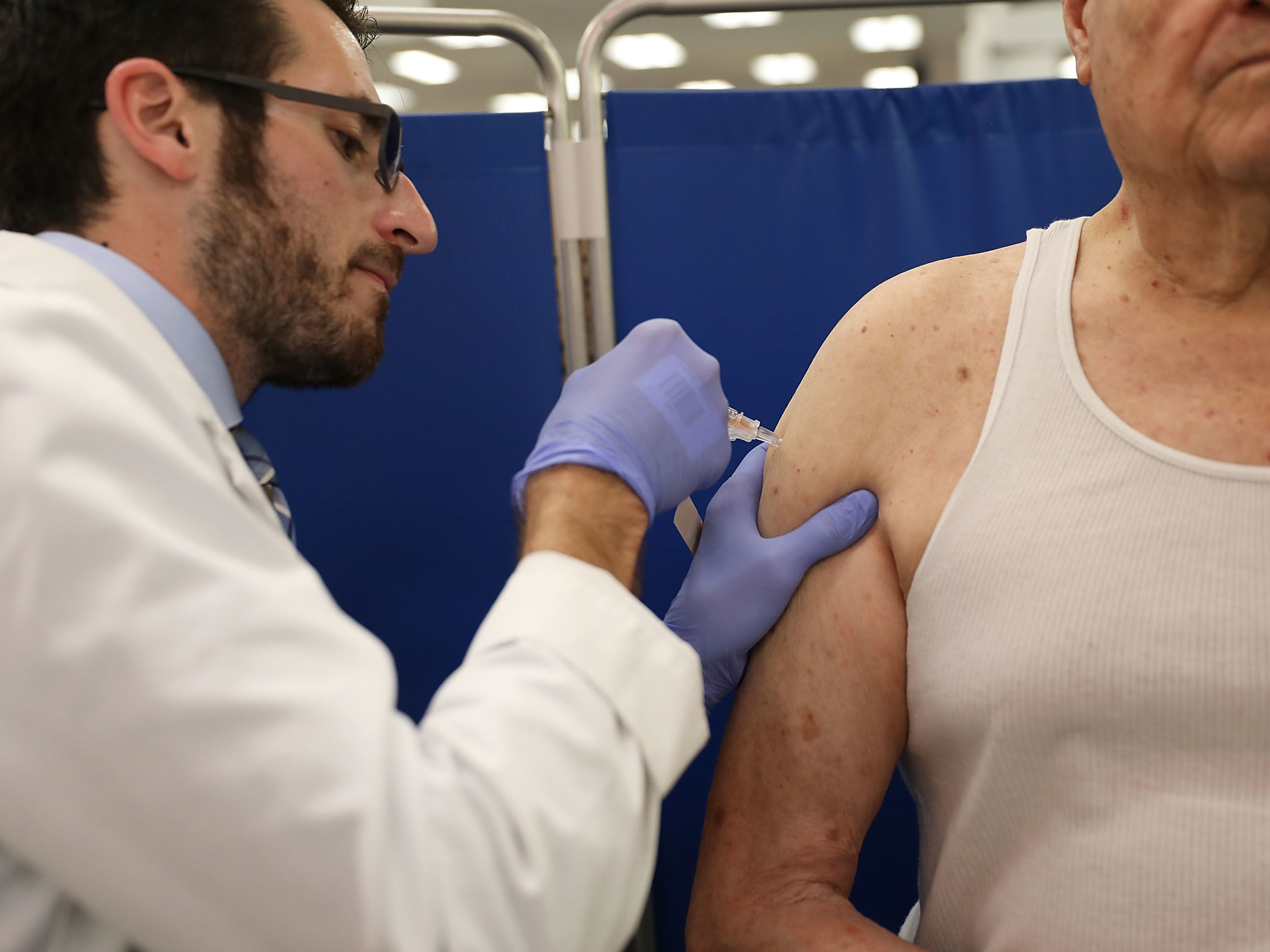 caption: Pharmacist Raphael Lynne gives a flu shot in Miami in 2018. This year's vaccination against influenza has been reducing infections by "about 40 to 50 percent," says Emily Martin, an epidemiologist with the University of Michigan School of Public Health.