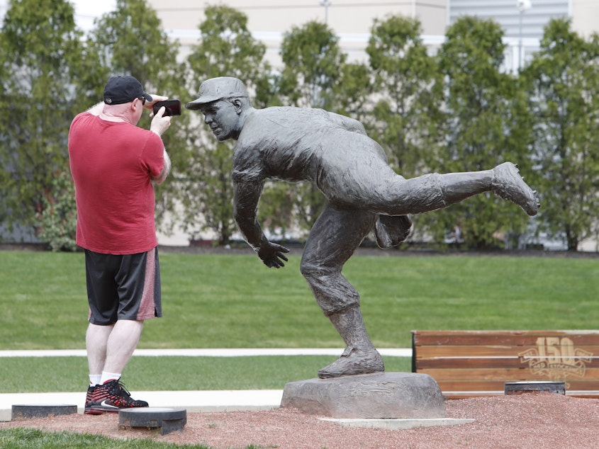 caption: The closest fans can get to Major League Baseball during the coronavirus hiatus — a statue outside Great American Ball Park yesterday in Cincinnati.