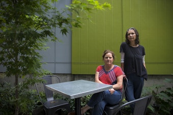 caption: Co-owners of Petite Soif, Lauren Feldman, left, and Shawn Mead, right, are portrayed in the patio area of their business on Thursday, July 16, 2020, along Beacon Avenue South in Seattle.