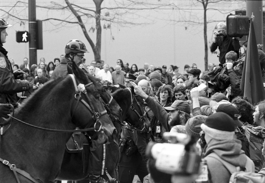 caption: Mounted police with protesters in Seattle Nov. 29, 1999.