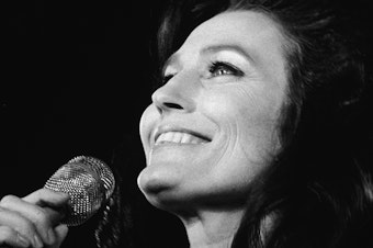 caption: Loretta Lynn performs on stage in California in 1972.