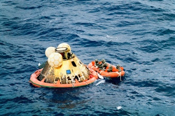 caption: The crew of Apollo 11 is picked up after its splashdown.