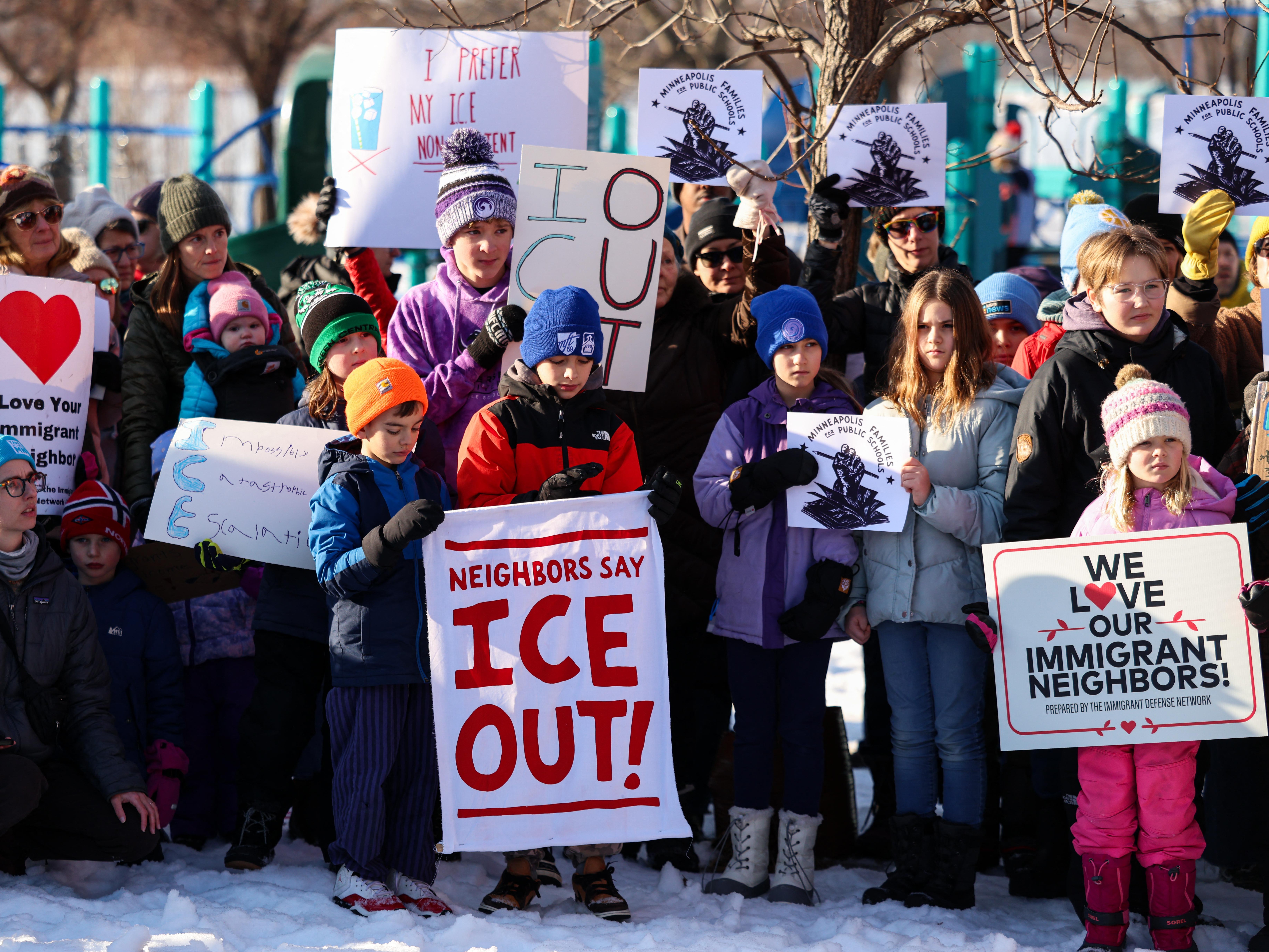 caption: People observe a moment of silence in Minneapolis at a news conference organized by the group Minneapolis Families for Public Schools. Protesters across the country are expressing outrage over the killing of Renee Good by an ICE agent, as well as a shooting by Border Patrol agents in Portland, Ore.