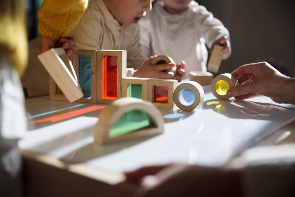 caption: Child care is impacting the costs families have to pay. (Lourdes Balduque/Getty Images)