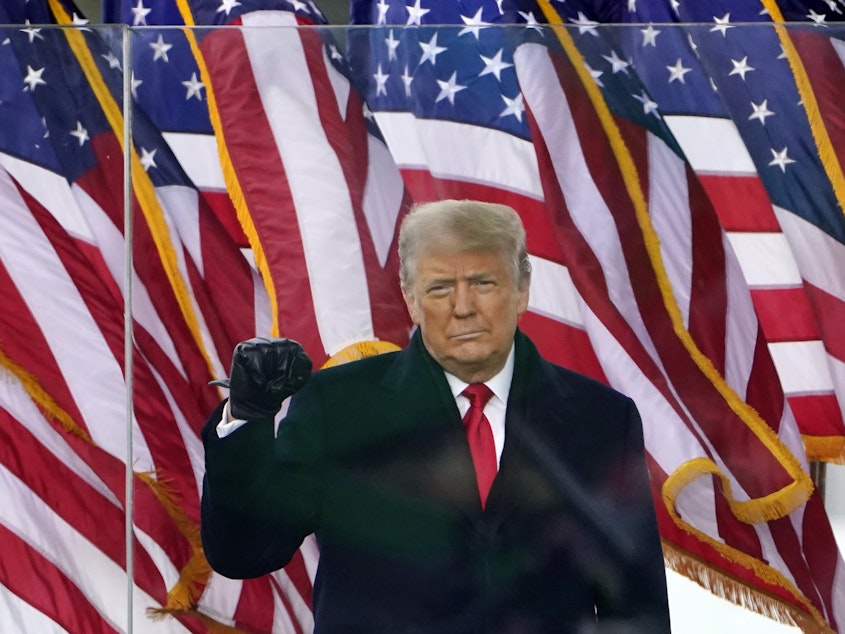 caption: Then-President Donald Trump gestures as he arrives to speak at a rally in Washington, on Jan. 6, 2021.