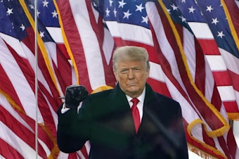 caption: Then-President Donald Trump gestures as he arrives to speak at a rally in Washington, on Jan. 6, 2021.