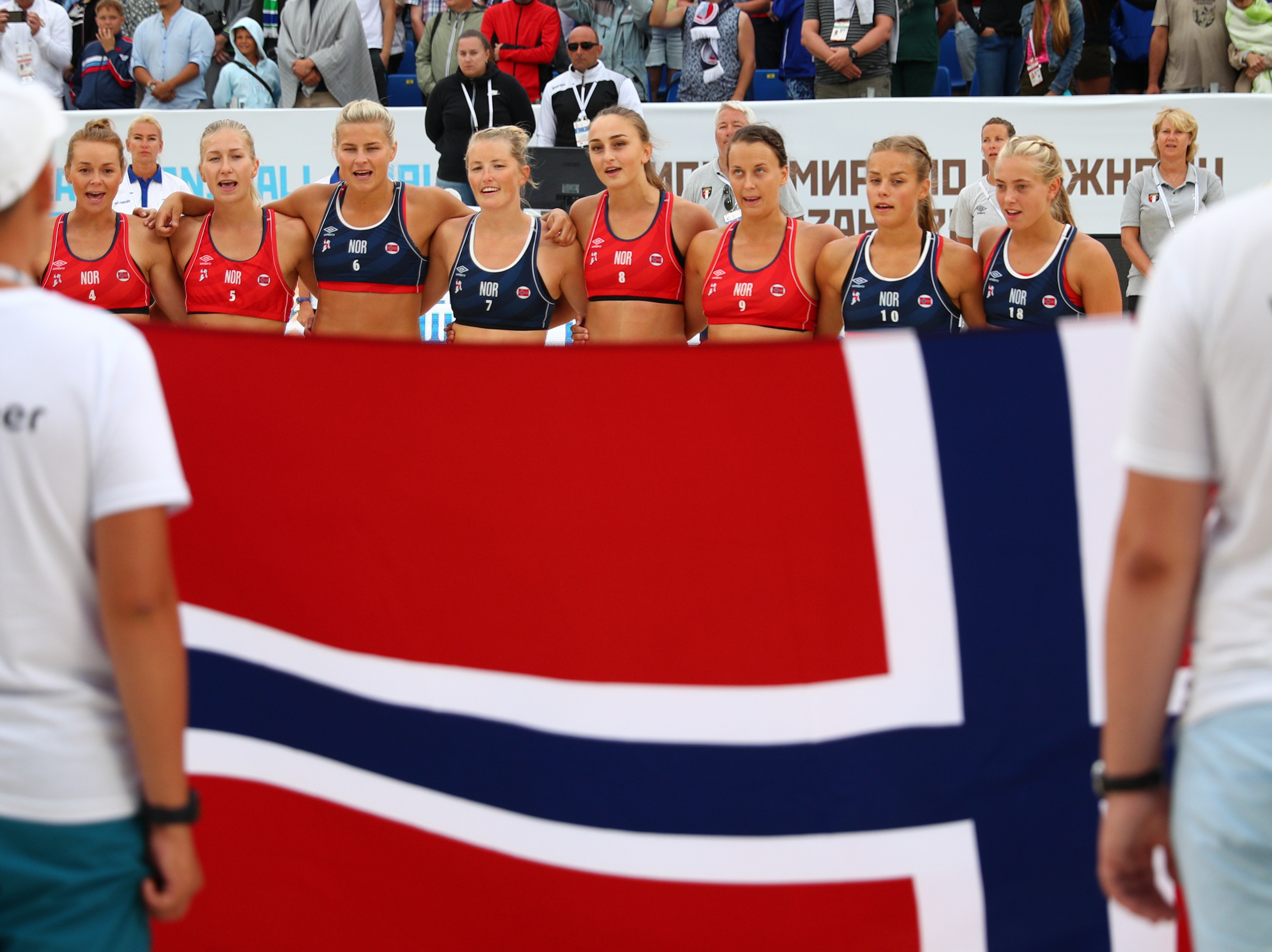 caption: Norway's team lines up during the 2018 Women's Beach Handball World Cup final against Greece on July 29, 2018 in Kazan, Russia.