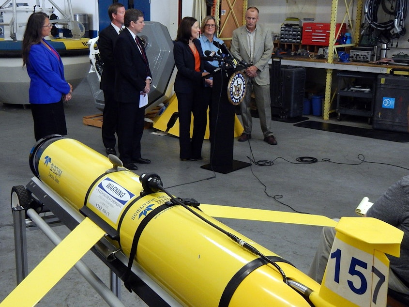 caption: Sen. Maria Cantwell speaks at a press conference next to a "wave glider" of the kind currently being used to monitor ocean acidification in the Gulf of Alaska. 