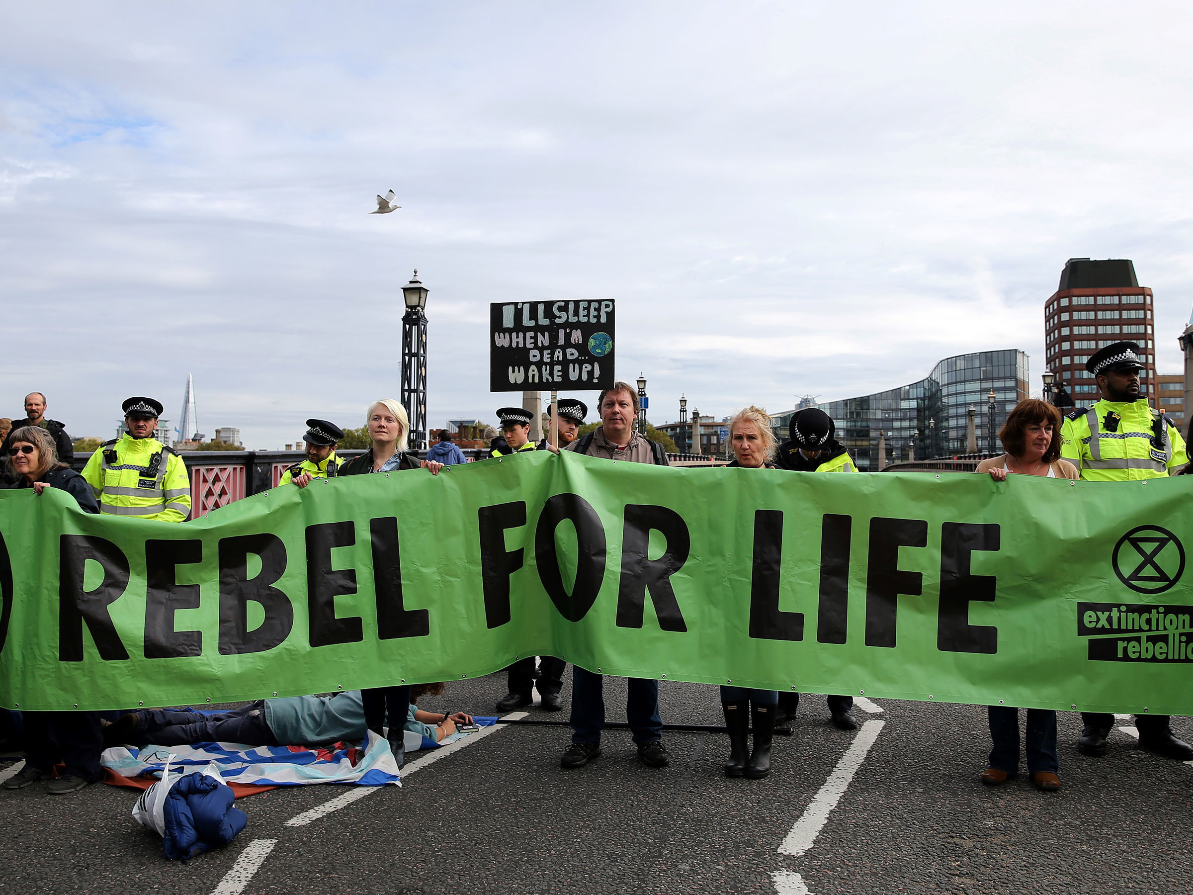 caption: Climate change activists from the group Extinction Rebellion demonstrate on Lambeth Bridge in central London on Monday. The group has planned protests in Europe, North America and Australia over the next two weeks.